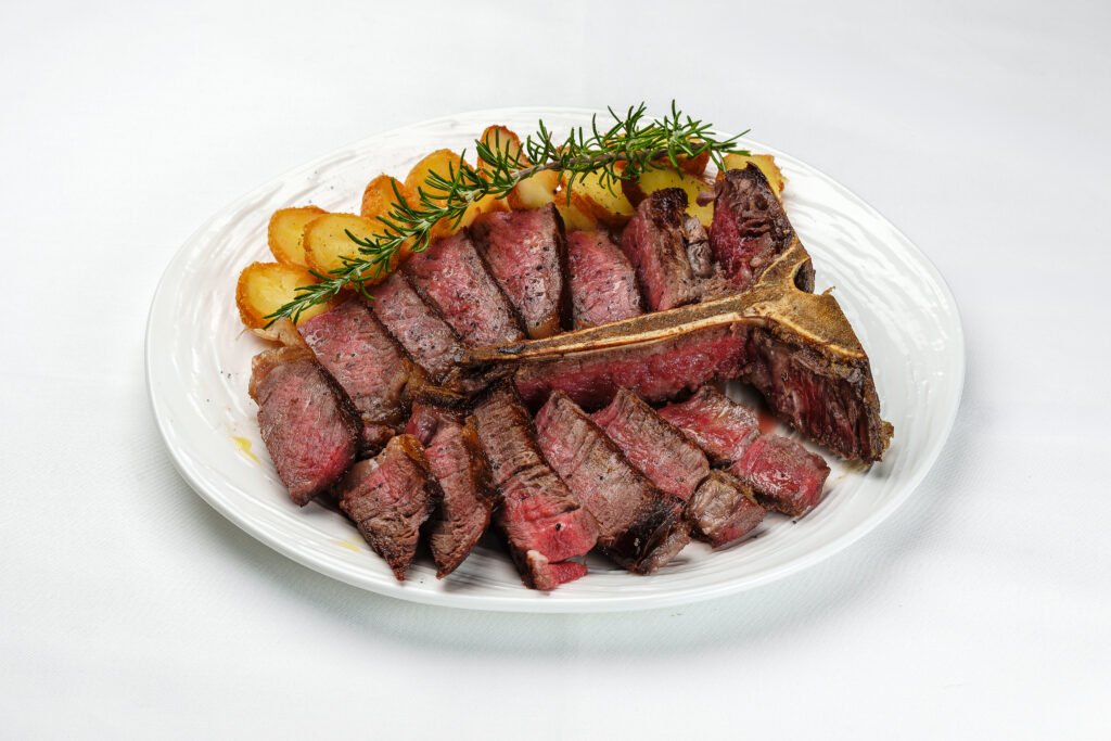 Dry-aged T-bone steak with roasted potatoes and rosemary at Pietra