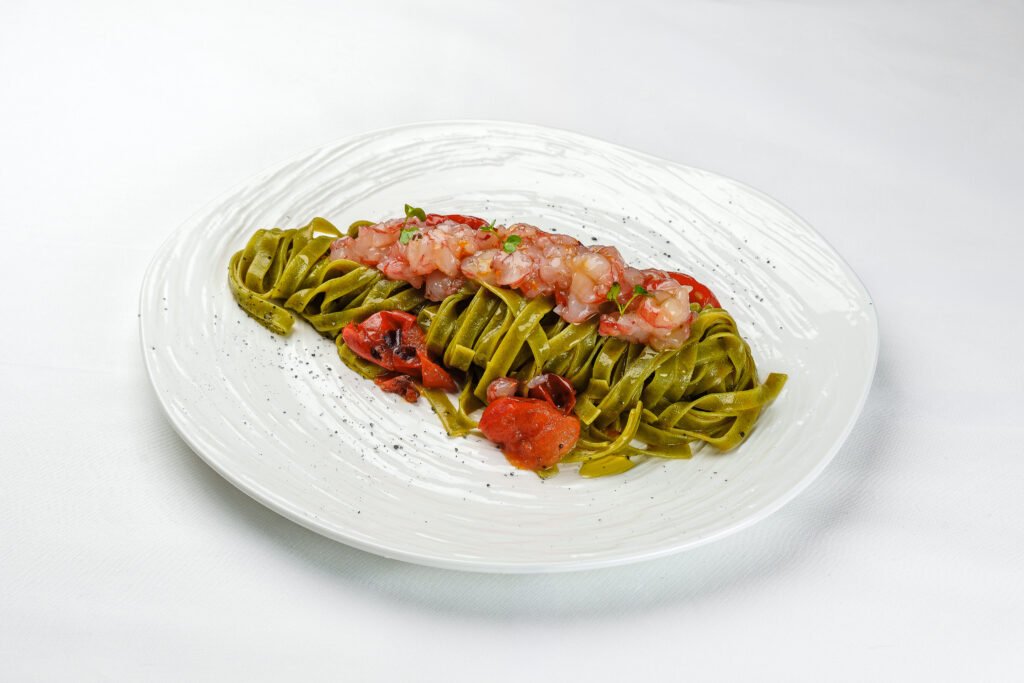 Spinach tagliatelle with prawns and cherry tomatoes at Pietra, Pržno